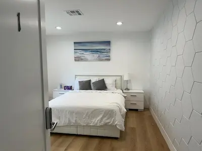 a bedroom with a bed and a painting on the wall at Modern comfort private room 1 in Los Angeles