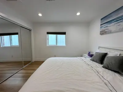 a bedroom with a large bed with a large mirror at Modern comfort private room 1 in Los Angeles