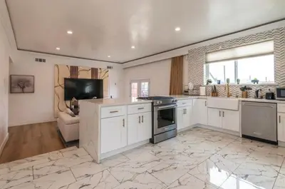 a large kitchen with white cabinets and a stove at Stylish Retreat Private Room 2 in Los Angeles