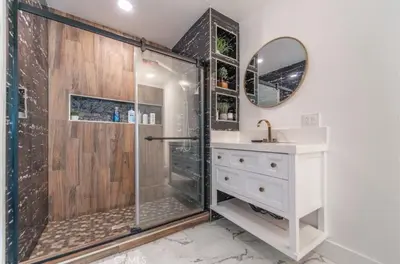 a bathroom with a shower and a sink and a mirror at Charming Private Room 4 in Los Angeles