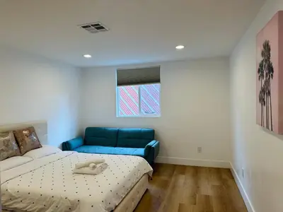 a room with a bed and a couch in it at Chic and Secure Private room in modern home 6 in Los Angeles