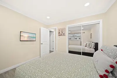 a white bedroom with a bed and a mirror at Elegant Exclusive Escape In Downtown Los Angeles in Alhambra