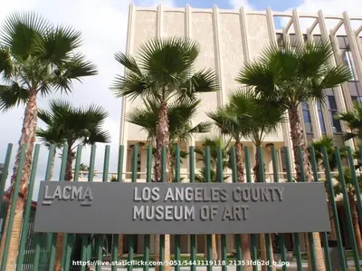 a sign in front of a building with palm trees at Elegant Exclusive Escape In Downtown Los Angeles in Alhambra