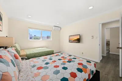 a bedroom with a bed and a living room at Blissful Utopia near Downtown LA in Alhambra