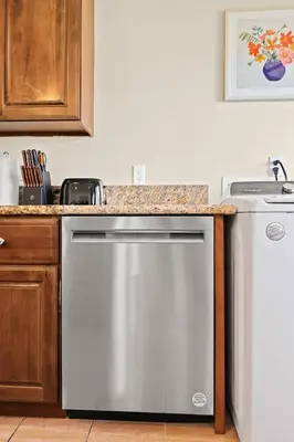 a kitchen with a stainless steel dishwasher and a counter at Blissful Utopia near Downtown LA in Alhambra