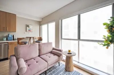 a living room with a couch and a table at Comfy studio near SM Promenade! Free parking! in Los Angeles
