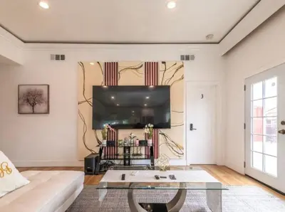 a living room with a couch and a flat screen tv at Contemporary Private Room 7 in Los Angeles