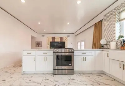a kitchen with white cabinets and a stove at Contemporary Private Room 7 in Los Angeles