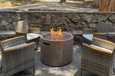two chairs and a fire pit in a patio at Natures Reserve in Lake Arrowhead