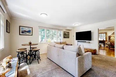 a living room with a couch and a tv at Natures Reserve in Lake Arrowhead