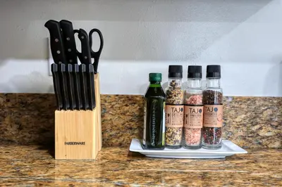two knives and bottles of spices on a counter at Idyllic Paradise Near Downtown Los Angeles in Alhambra