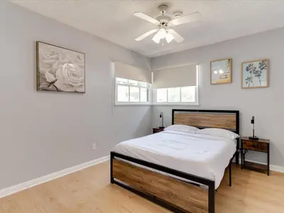 a white bedroom with a bed and a ceiling fan at Charming 5 Bedroom Granada Hills House with Pool in Los Angeles