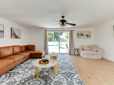 a living room with a couch and a table at Charming 5 Bedroom Granada Hills House with Pool in Los Angeles