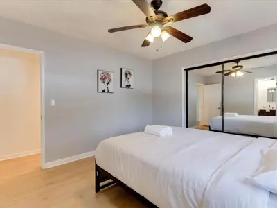 a bedroom with a bed and a ceiling fan at Charming 5 Bedroom Granada Hills House with Pool in Los Angeles