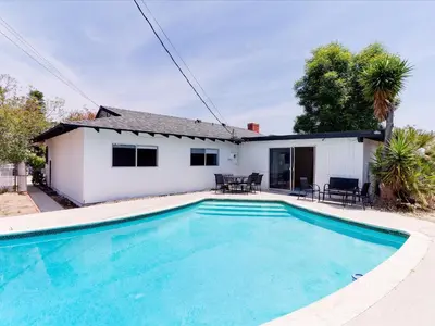 a swimming pool in front of a house at Charming 5 Bedroom Granada Hills House with Pool in Los Angeles