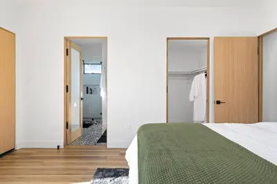 a bedroom with a bed and a hallway with a mirror at Rooftop 3B 3BA House Near Dodger Stadium and DTLA in Los Angeles