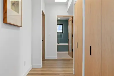 a hallway with a door leading to a bathroom at Rooftop 3B 3BA House Near Dodger Stadium and DTLA in Los Angeles