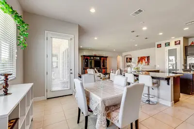 a dining room and kitchen with a table and chairs at Beautiful Bakersfield Home about 8 Mi to Downtown! in Bakersfield
