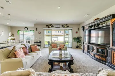 a living room with a couch and a tv at Beautiful Bakersfield Home about 8 Mi to Downtown! in Bakersfield