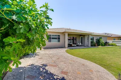 a house with a driveway in front of it at Beautiful Bakersfield Home about 8 Mi to Downtown! in Bakersfield