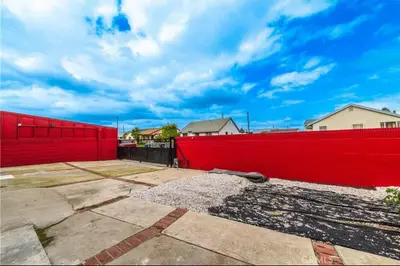 a red fence with houses in the background at Elegant Living Private Room in Modern Home 9 in Los Angeles