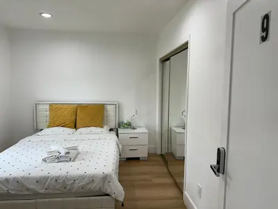 a white bedroom with a bed and a mirror at Elegant Living Private Room in Modern Home 9 in Los Angeles
