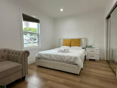 a bedroom with a bed and a chair and a window at Elegant Living Private Room in Modern Home 9 in Los Angeles