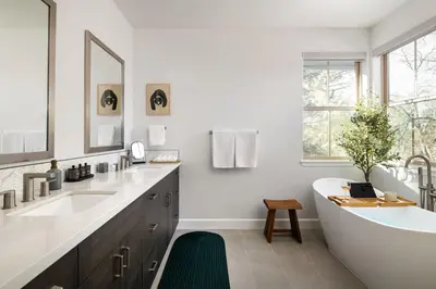 a white bathroom with a tub and two sinks at Aspen Glen Modern Retreat in Big Bear Lake
