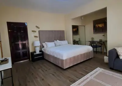 a bedroom with a large white bed and a couch at Audrey Studio Apartment in Ktown in Los Angeles