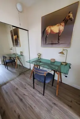 a room with a table and a picture of a horse on the wall at Audrey Studio Apartment in Ktown in Los Angeles