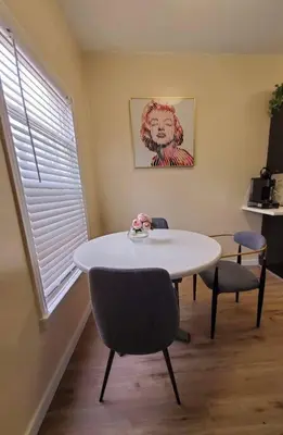 a dining room with a table and chairs and a window at Audrey Studio Apartment in Ktown in Los Angeles