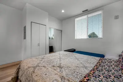 a white bedroom with a bed and a window at Modern 1-Bedroom Loft in Hollywood with Parking, WiFi & Hollywood Sign View in Los Angeles