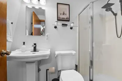 a bathroom with a toilet and a sink and a shower at Hillcrest HappyNest - Hot tub, fire pit, gas grill in Big Bear Lake