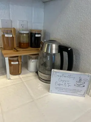 a coffee pot sitting on top of a counter with a sign at Hillcrest HappyNest - Hot tub, fire pit, gas grill in Big Bear Lake
