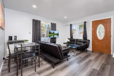 a living room with a table and a dining room at Deluxe Modern 2BR Apt in Prime Location in Los Angeles