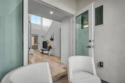 two white chairs in a room with a hallway at Chic Modern Loft in Hollywood 1 Bedroom with Balcony & Free Secure Parking in Los Angeles