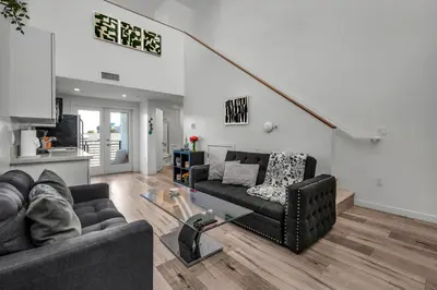 a living room with a couch and a table at Stylish Modern one Bedroom Hollywood Loft With in unite washer dryer & Balcony in Los Angeles