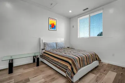 a bedroom with a bed and a window at Stylish Modern one Bedroom Hollywood Loft With in unite washer dryer & Balcony in Los Angeles