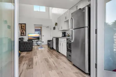a kitchen with a stainless steel refrigerator at Stylish Modern one Bedroom Hollywood Loft With in unite washer dryer & Balcony in Los Angeles