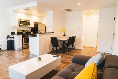 a living room with a couch and a table at Chic Large 1 Bedroom Apartment in Koreatown with Dining Area Free Gated Parking in Los Angeles