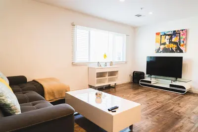 a living room with a couch and a tv at Chic Large 1 Bedroom Apartment in Koreatown with Dining Area Free Gated Parking in Los Angeles