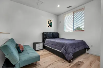 a bedroom with a bed and a chair and a window at 1-Bedroom Lofts in Hollywood Modern Design, Balcony, Parking & Hollywood Sign in Los Angeles