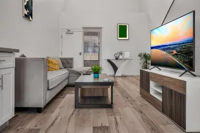 a living room with a couch and a flat screen tv at Modern 1 Bedroom Loft in Hollywood with Full Kitchen and Central AC Free Gated Parking in Los Angeles