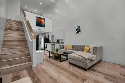 a living room with a couch and a table at Modern 1 Bedroom Loft in Hollywood with Full Kitchen and Central AC Free Gated Parking in Los Angeles