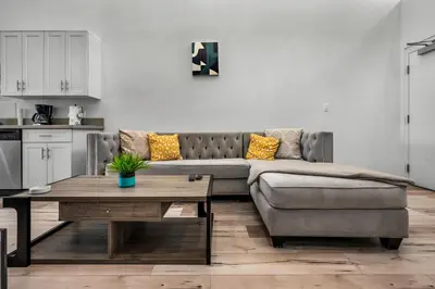 a living room with a couch and a table at Modern 1 Bedroom Loft in Hollywood with Full Kitchen and Central AC Free Gated Parking in Los Angeles