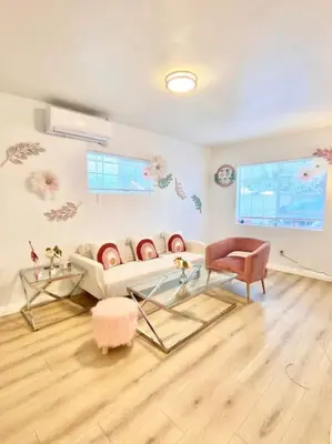a living room with a couch and a table at Pink Cozy house 2 bedrooms in Rosemead