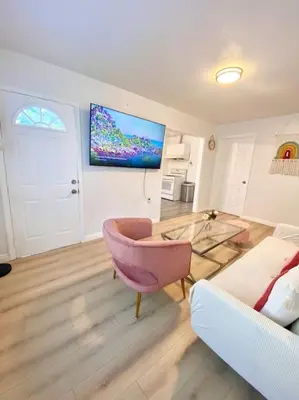 a living room with a couch and a glass table at Pink Cozy house 2 bedrooms in Rosemead