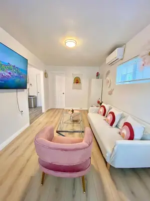 a living room with a couch and a table at Pink Cozy house 2 bedrooms in Rosemead