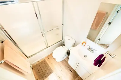 a bathroom with a shower and a toilet and a sink at Unique 3-Level Loft with One bedroom & Two Full Bathroom in Los Angeles