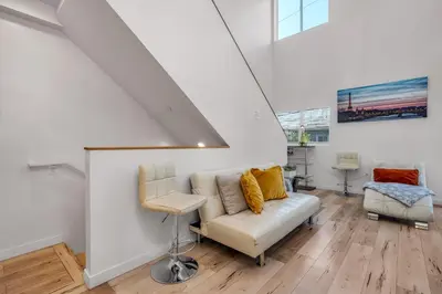 a living room with a couch and a chair at Chic 2 Bedroom 2 Bathroom 3 Level Loft Style Condo by Hollywood Free Gated Parking Full kitchen in Los Angeles